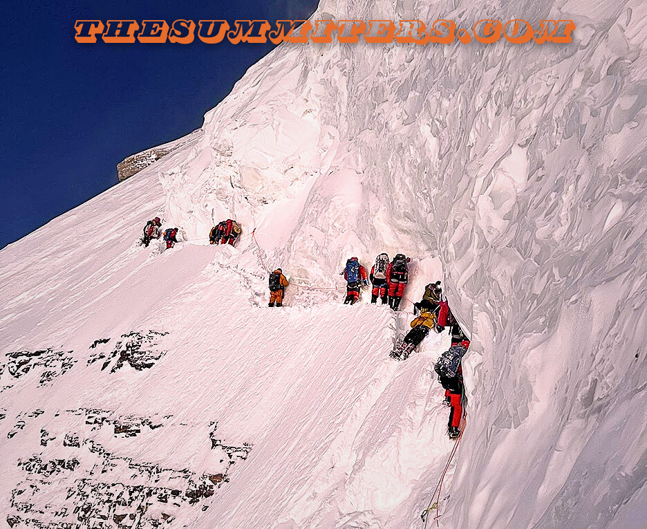 Climbers move around Hassan lying on the snow. Photo: Lakpa Sherpa